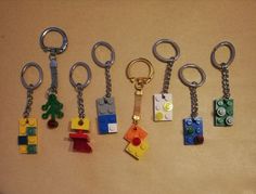 six lego keychains are arranged on a table