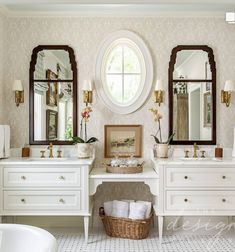 a white bathroom with two sinks and mirrors