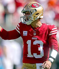 a man in a football uniform throwing a ball