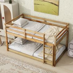 a wooden bunk bed sitting on top of a hard wood floor next to a rug