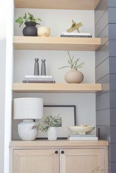 shelves with vases, books and other items on them