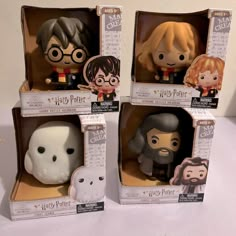 three harry potter figurines in their boxes