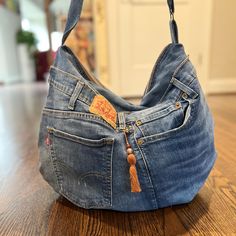 an old pair of jeans with a tasseled pocket is sitting on the floor