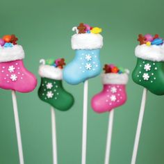 four christmas stocking lollipops on top of toothpicks