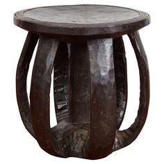 a wooden table with three curved legs and a circular top on the bottom is made out of wood