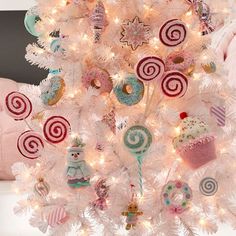 a white christmas tree decorated with candies and lollipops