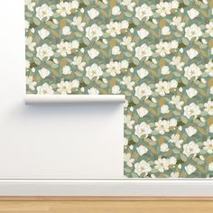 a wallpaper with white flowers on it next to a wooden floor and door frame