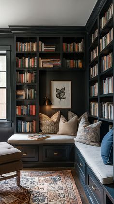 a living room filled with lots of bookshelves next to a couch and ottoman