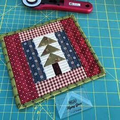 the quilt is being sewn together and ready to be made into a christmas tree ornament