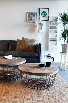 a living room filled with furniture and a coffee table on top of a woven rug