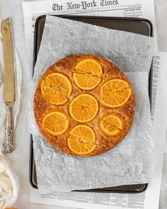 an orange phylo cake on a tray with some slices cut out and ready to be eaten