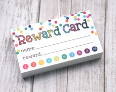 a reward card sitting on top of a wooden table