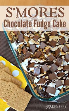 s'mores chocolate fudge cake in a glass dish with graham crackers