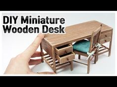 a miniature wooden desk and chair with the words diy miniature wooden desk