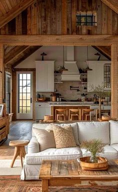 a living room filled with furniture next to a wooden wall and ceiling covered in wood planks