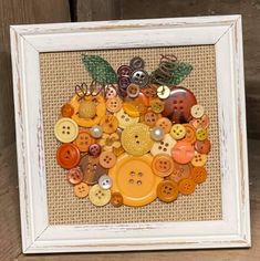 a white frame with buttons and leaves on it