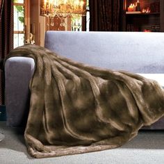 a living room with a couch covered in a blanket