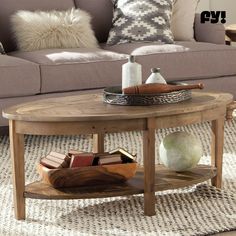 a living room with a couch, coffee table and pillows on the carpeted floor