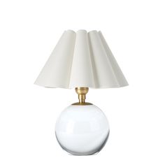 a white table lamp with a gold base and shade on the top, against a white background