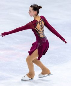 a female figure skating on an ice rink