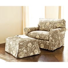 a living room with a chair and ottoman