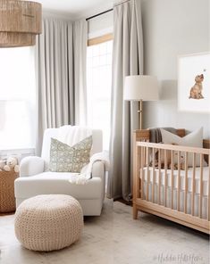 a baby's room with a crib, rocking chair, and large window