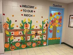 a classroom door decorated for fall with pumpkins and leaves on the front, and welcome to our patch