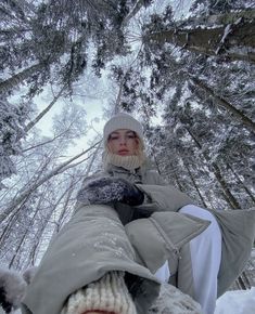 a woman sitting in the snow with her feet up