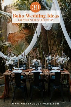 a table set up for a wedding reception with white draping and greenery