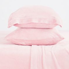 two pink pillows on top of each other