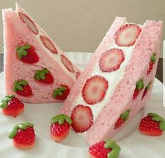 two slices of strawberry cake with strawberries on the top and one slice cut in half