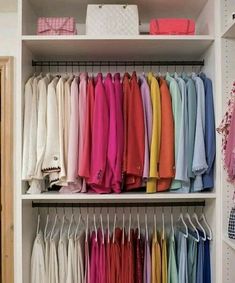 the closet is full of colorful shirts and pants