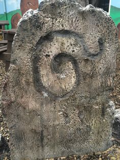 a large rock with a spiral design on it