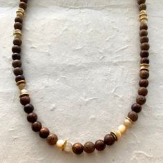 Wood beads Mother of Pearl 18" Length The "milky" look of the Mother of Pearl makes this necklace just stand out. The neutral colors are complimented well with the wood brown beads. Wood Beaded Jewelry, Brown Necklace Beads, Brown Bead Necklace, Wood Beads Necklace, Adjustable Brown Wooden Necklaces, Brown Wooden Beads Holistic Necklace, Adjustable Brown Necklace With 8mm Beads, Holistic Brown Necklaces With Wooden Beads, Brown Wooden Beads Necklace For Meditation