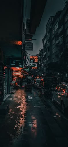 an empty city street at night in the rain