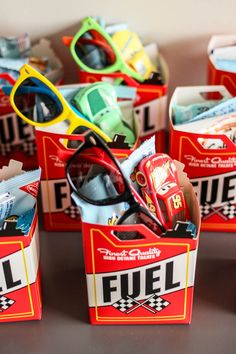 several small boxes filled with assorted sunglasses and other items sitting on top of a table