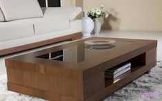 a living room with white couches and a coffee table in the middle on carpeted flooring