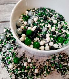 a bowl filled with green and white candies