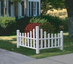 a white picket fence sitting on the side of a road