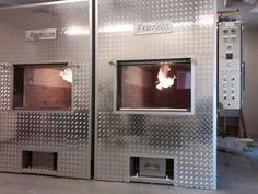 two ovens that are sitting side by side in a room with no one around them