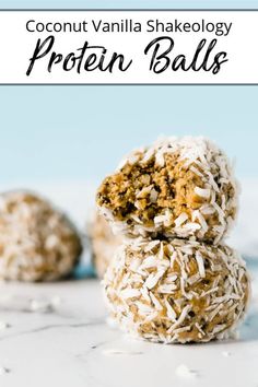 three coconut balls stacked on top of each other in front of a blue background with white sprinkles