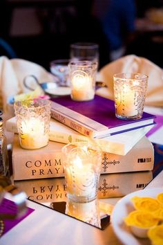 candles are lit on top of some books