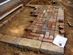 bricks laid out on the ground in front of a house