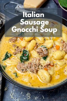 italian sausage and gnocchi soup in a black bowl with spinach on the side