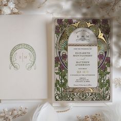 a wedding card with an ornate design on the front and back, surrounded by flowers