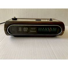 an alarm clock radio sitting on top of a table