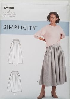 a woman wearing a skirt and sweater with the words simpl city written on it