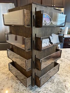 an image of a wooden display case in the middle of a kitchen counter with labels and magnets on it