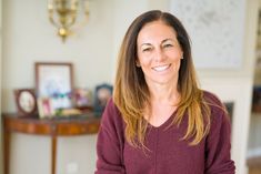 a woman smiling in her living room