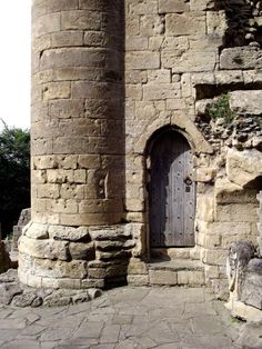 an old stone building with a wooden door